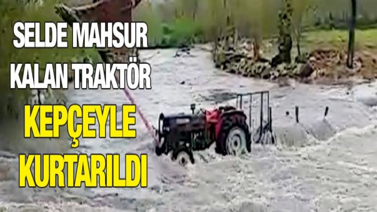 Selde mahsur kalan traktör kepçeyle kurtarıldı