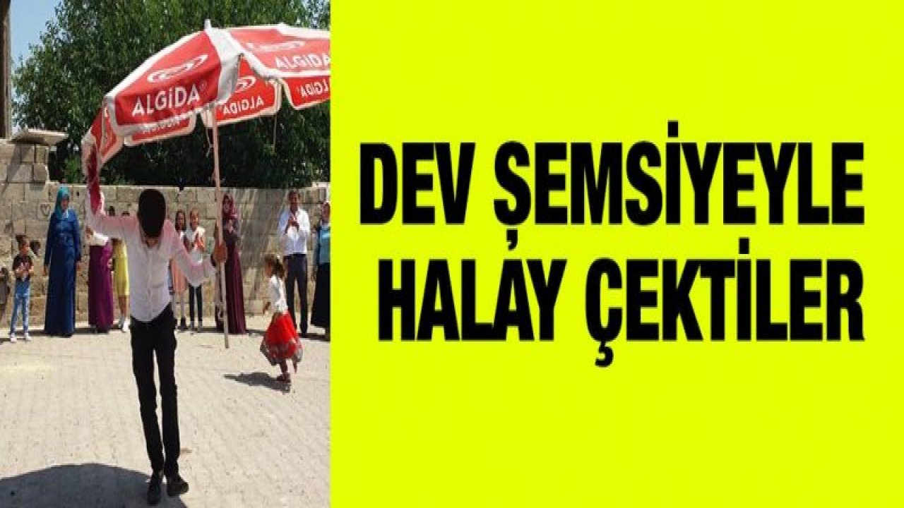 Kavurucu sıcak altında dev şemsiye ile halay